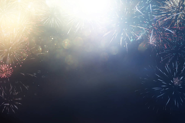 abstract black and gold glitter background with fireworks. christmas eve, 4th of july holiday concept - 写真・画像