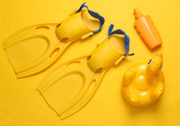 Beach accessories on a yellow background. Top view. Flat lay - Photo, Image