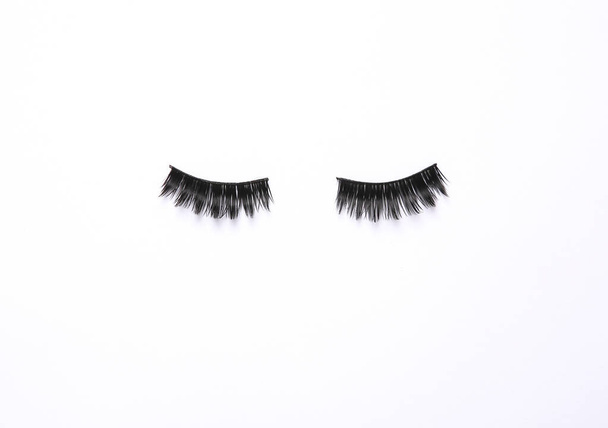 False eyelashes on white background. Beauty concept - Photo, Image