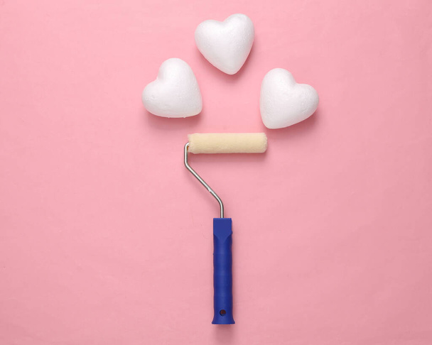 Paint roller with hearts on pink background. Romantic, love concept, valentine's day - Photo, Image