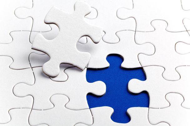 Plain white jigsaw puzzle, on Blue background - Photo, Image