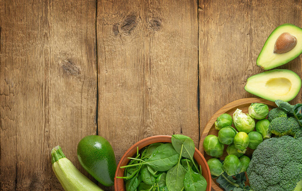 Green vegetables selection on wooden background. Top view, copy space. - Foto, imagen