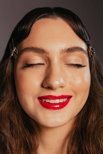 Portraits of a beautiful girl with makeup and red lips - Foto, Imagen