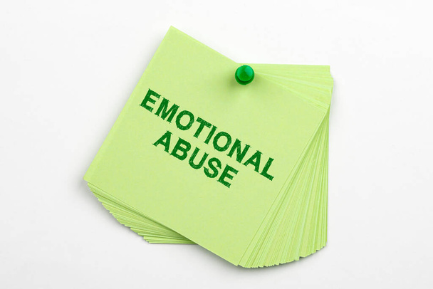 Text caption presenting Emotional Abuse. Business concept person subjecting or exposing another person to behavior Multiple Assorted Collection Office Stationery Photo Placed Over Table - Photo, Image