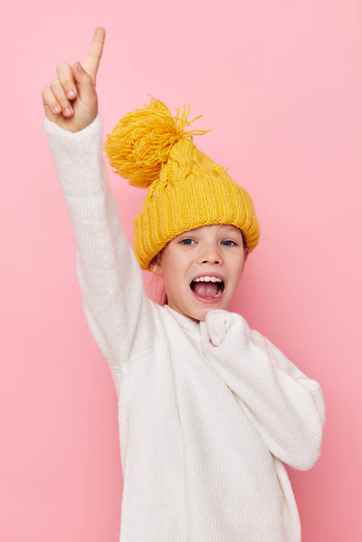 Portrait of happy smiling child girl in a sweater and a hat childhood unaltered - Фото, изображение