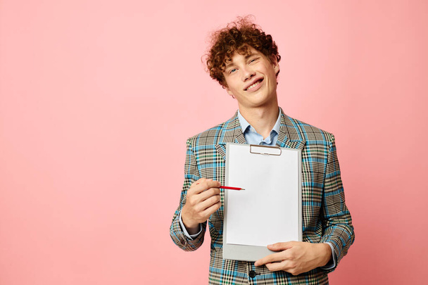 guy with red curly hair in a plaid jacket copy-space folder isolated background unaltered - Foto, Bild