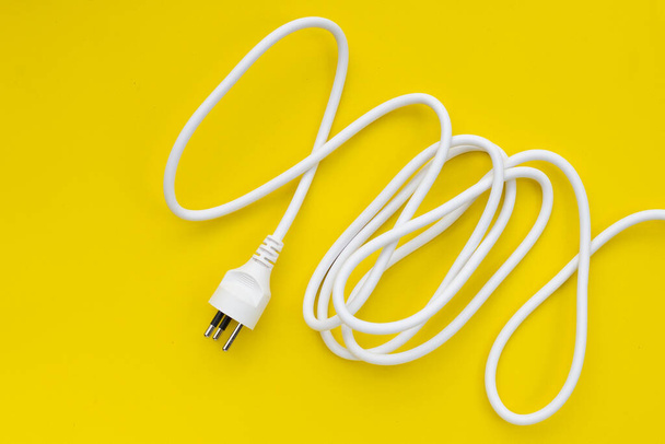 Electrical plug on yellow background. - Foto, Imagen