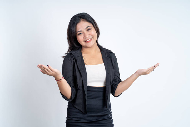 Excited young asian woman opening two palms while smiling - 写真・画像