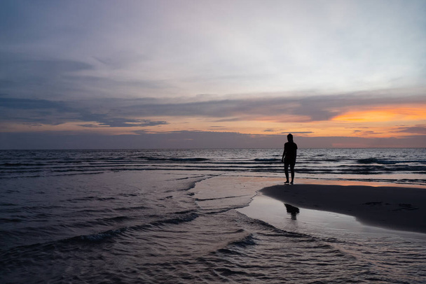 Silhouette of Woman Stanidng on Beach at Sunset - Φωτογραφία, εικόνα