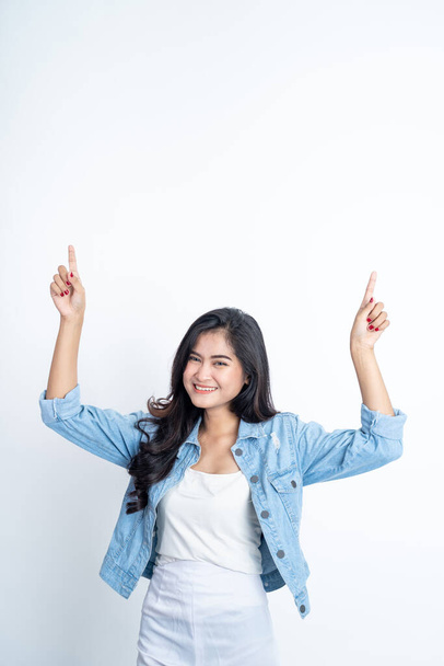 young woman with two finger pointing up - Photo, image