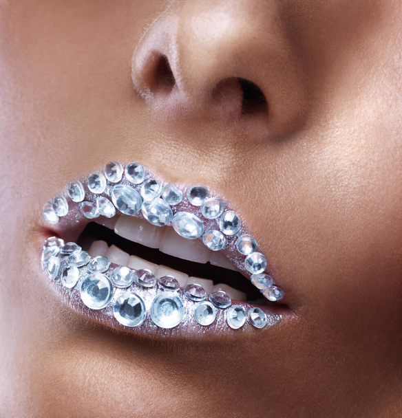 Diamonds are a girls best friend. Studio shot of a beautiful young woman with sparkling lips. - 写真・画像