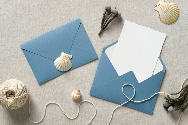 Wedding stationery set. Blue envelopes, wedding invitation mockup, seashells top view. Nautical, sea, marine style wedding. - Photo, Image