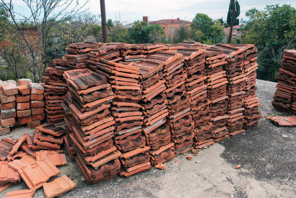 Stacks of used red ceramic roofing tiles - Photo, Image