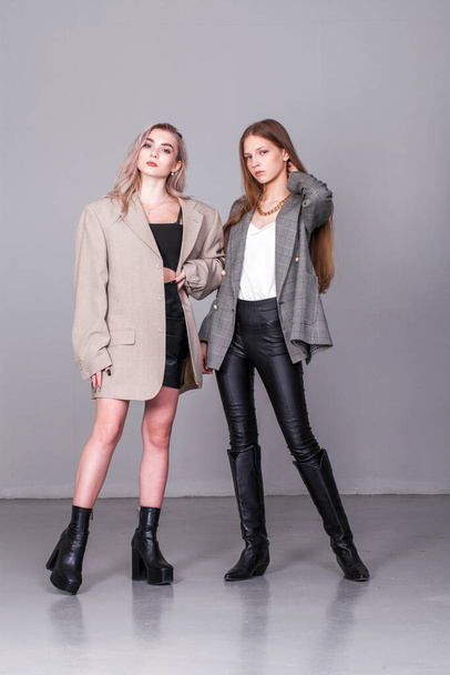Two fashion portrait of a young beautiful blonde models - Foto, imagen