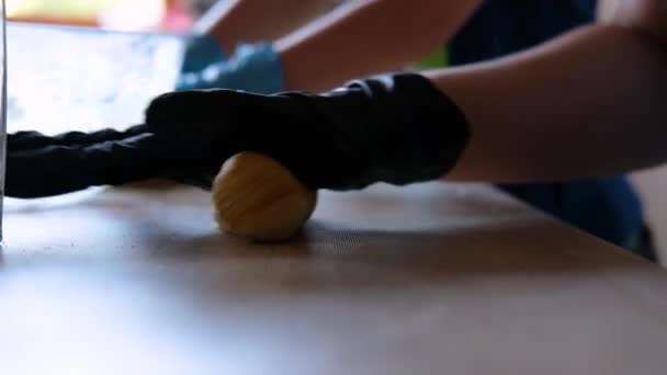 Frauenhände in Handschuhen kneten den Teig - Filmmaterial, Video