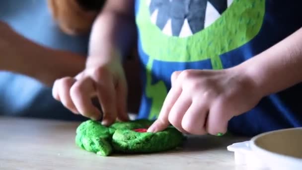 The child uses a plastic mold to shape the dough - Footage, Video