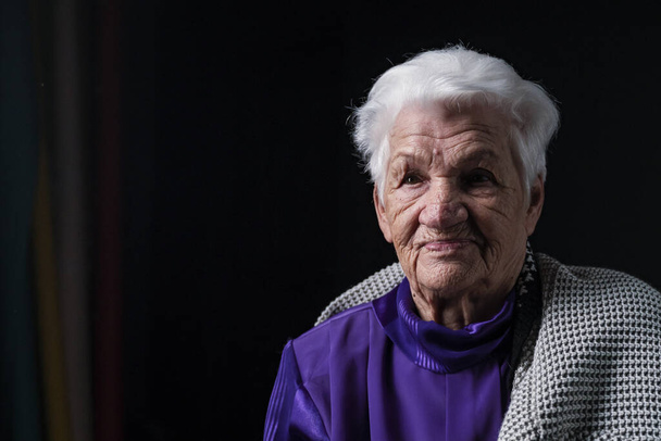 Ritratto di donna anziana seria su sfondo nero - Foto, immagini