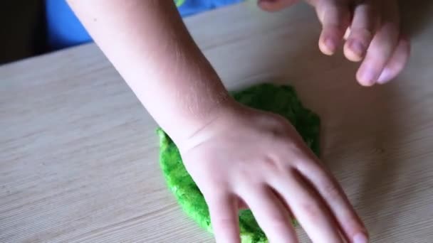The child uses a plastic mold to shape the dough - Footage, Video