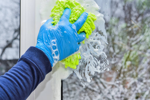 Sponge and foam on glass when cleaning and washing window. House cleaning works and services. Window cleaning job and business. - Φωτογραφία, εικόνα
