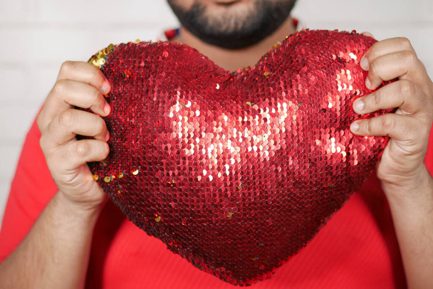 young man holding big red heart close up  - Φωτογραφία, εικόνα