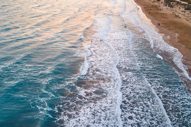 Waves splash to sandy beach - Фото, изображение