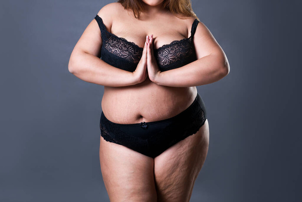 Plus size sexy model in black lingerie, fat woman on gray studio background, overweight female body with stretch marks - Fotoğraf, Görsel