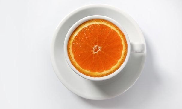 Orange slice in a coffee cup - Фото, зображення