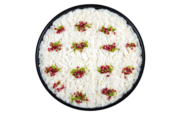 Turkish Traditional Ramadan Dessert Gullac on the table. It is made with gullac, milk, rose water, walnut, vanilla. It is decorated with pomegranate and pistachio. Dessert from Ottoman Cuisine - Photo, Image
