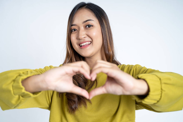 close up of beautiful woman in heart shape with fingers - Photo, image