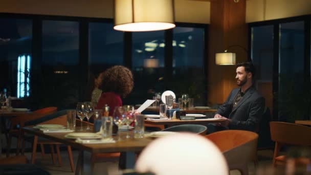Romantičtí milenci sedí spolu v restauraci. Multietnický pár na rande u večeře. - Záběry, video