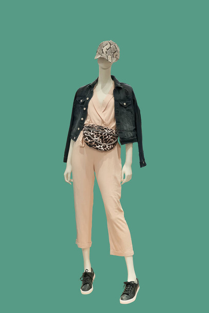 Full length image of a female display mannequin wearing fashionable clothes isolated on a green background - Valokuva, kuva