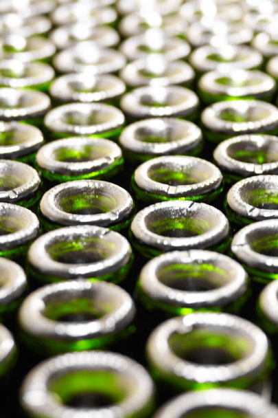 Ready for filling. Cropped closeup of green tops of wine bottles. - Photo, Image