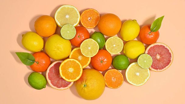 Summer citrus fruits arrangement on pastel beige and blue background. Flat lay food concept - Foto, afbeelding