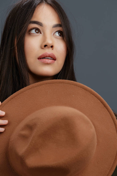 beautiful woman brown hat hand gestures fashion emotions Gray background - Φωτογραφία, εικόνα