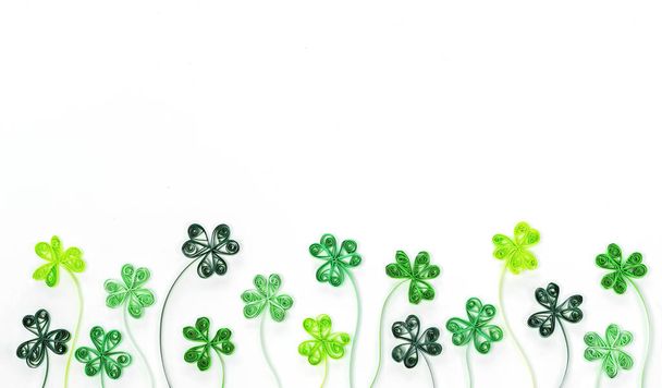 Quilling clover leaves for St. Patrick's Day banner. Green shamrock leaves made from rolled paper isolated on white background. Background for St. Patrick's Day with shamrock and trefoil. - Photo, Image