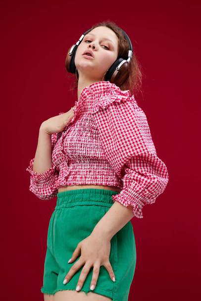 cheerful woman listening to music with headphones dance unaltered - Foto, Bild