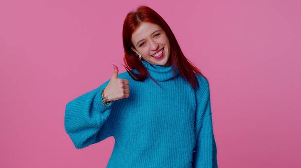 Teenager girl raises thumbs up agrees or gives positive reply recommends advertisement likes good - Photo, Image