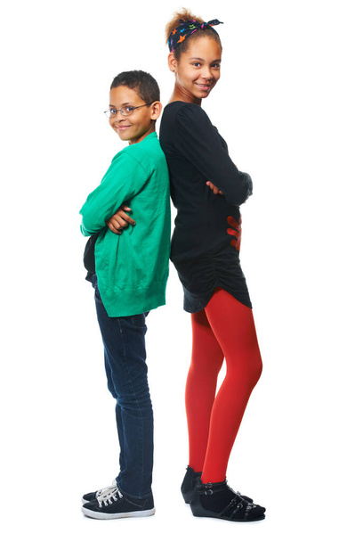 Youth in isolation. A studio shot of two adorable kids standing back to back. - Foto, Imagen