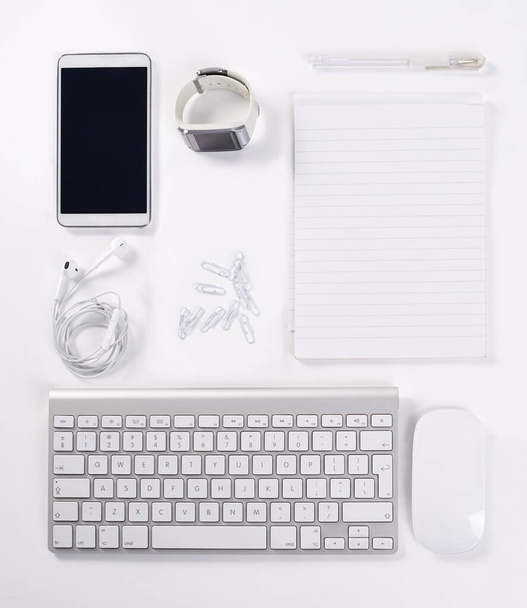 Equipped for productivity. A high angle view of various office equipment items and digital devices. - Fotó, kép