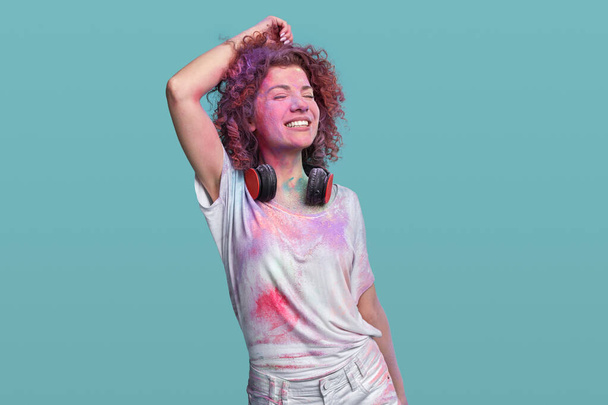 Content woman in Holi colors in studio - Photo, image