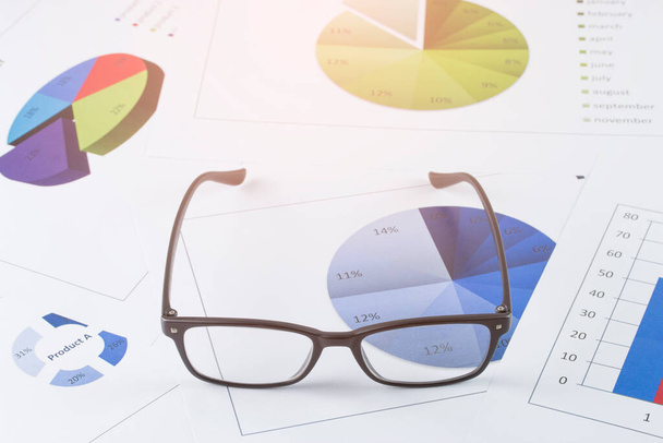 business concept : graph with glasses on stock market report as background - Фото, зображення