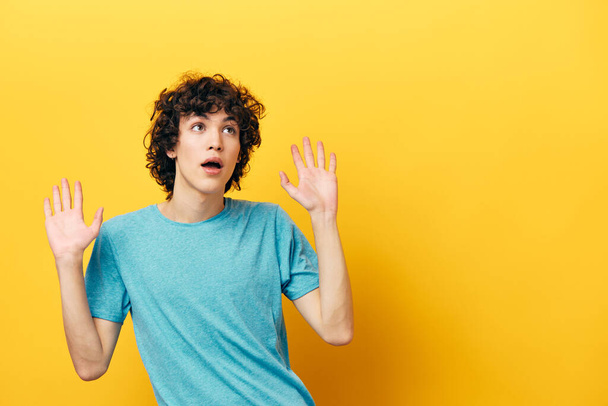 man in blue t-shirt shocked on yellow background - Photo, Image
