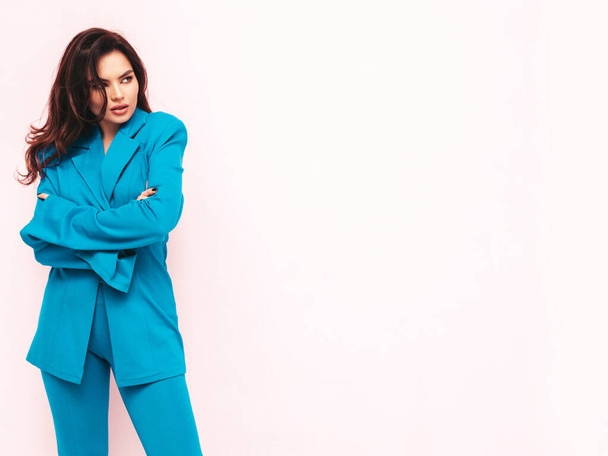 High fashion portrait of young beautiful brunette woman wearing nice trendy blue suit. Sexy fashion model posing in studio. Fashionable female isolated light pink - Φωτογραφία, εικόνα