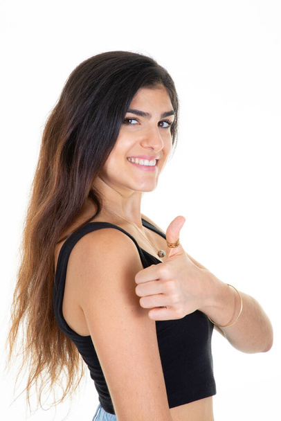 cute smiling young woman profile standing with finger thumbs up - Фото, изображение