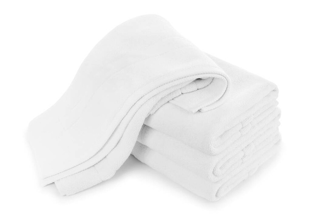 Empilement de serviettes pliées en coton blanc avec une chute sur le dessus - Photo, image