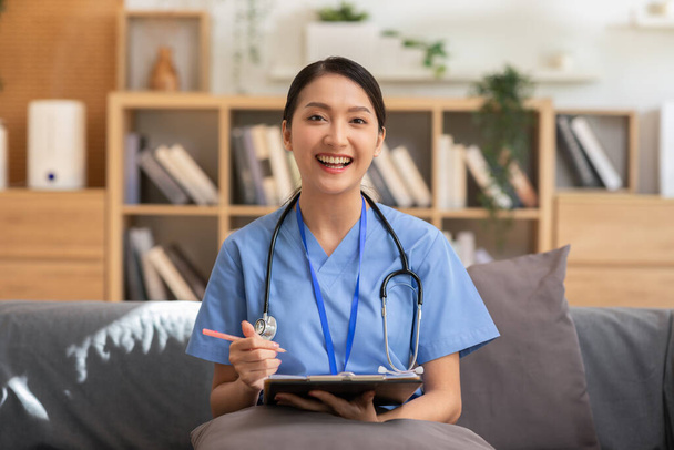 Camera view Asian doctor woman smile meeting online with patient to consult health for healthy wellness life,Smart Doctor wearing white coat with stethoscope Video Call at hospital,Telehealth concept - Photo, Image