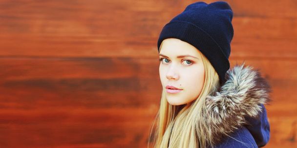 Portrait close up of beautiful young blonde woman wearing hat on wooden background - Fotografie, Obrázek