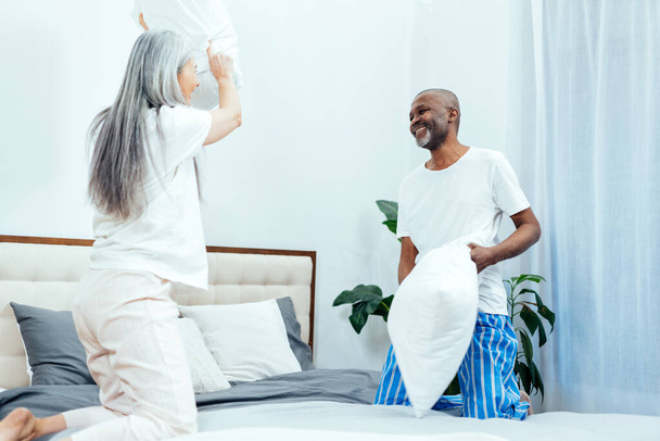 Cinematic image of an happy multiethnic senior couple. Indoors Lifestyle moments at home. Concept about seniority and relationships - Zdjęcie, obraz