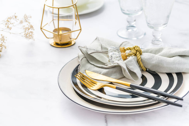 Image of cutlery sets with plate, cup and candle. Party theme, place and table setting. - Photo, Image