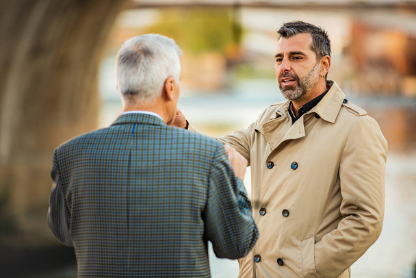 Dos increíbles hombres de negocios mayores están hablando entre sí, de cerca - Foto, imagen